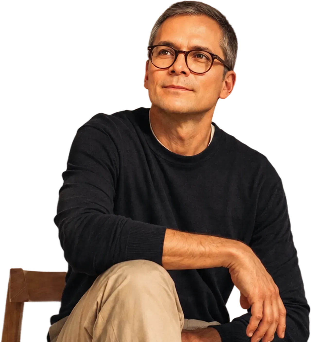 A man sitting against a sunlit wall